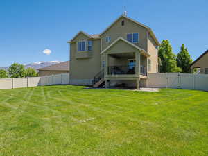 Back of house featuring a gate, stairway, stucco siding, and a mountain view