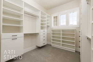 Walk in closet featuring dark carpet