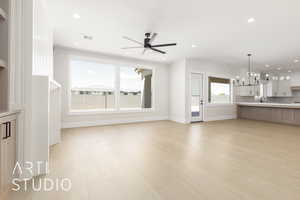 Unfurnished living room featuring a chandelier, light wood finished floors, baseboards, and recessed lighting