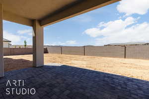 Fenced backyard with a patio area
