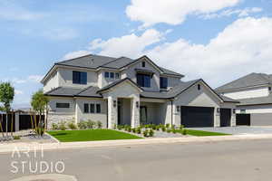 View of front of property featuring stone siding, stucco siding, decorative driveway, and an attached garage