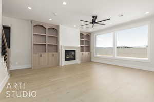 Unfurnished living room with ceiling fan, baseboards, a large fireplace, recessed lighting, and light wood finished floors