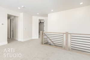 Spare room with light carpet, recessed lighting, baseboards, and a smoke detector