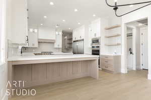 Kitchen featuring open shelves, built in appliances, a peninsula, backsplash, and recessed lighting