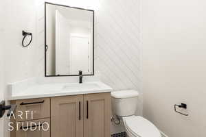 Half bathroom featuring toilet and vanity
