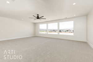 Spare room with light carpet, recessed lighting, a ceiling fan, and baseboards