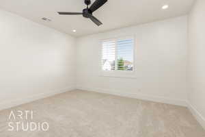 Spare room with carpet, ceiling fan, baseboards, and recessed lighting