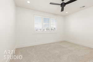Carpeted spare room with baseboards, ceiling fan, and recessed lighting