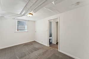 Unfurnished bedroom with baseboards and carpet flooring