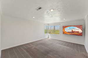 Carpeted spare room with visible vents, recessed lighting, and baseboards