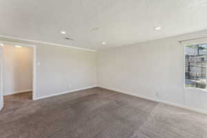 Unfurnished room with visible vents, carpet flooring, baseboards, and recessed lighting