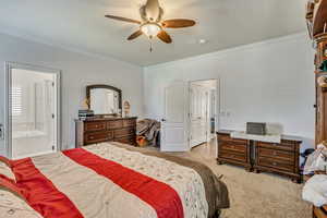 Bedroom with crown molding, carpet floors, connected bathroom, and ceiling fan