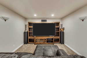 Carpeted living room featuring baseboards and recessed lighting