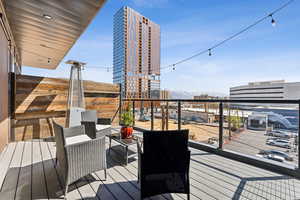 Wooden terrace with a view of city and a mountain view