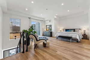 Bedroom featuring a wall mounted AC, access to outside, light wood finished floors, and recessed lighting