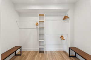 Walk in closet featuring wood finished floors