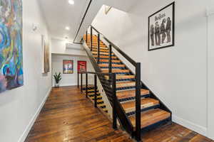 Stairs featuring baseboards, recessed lighting, hardwood / wood-style floors, and a wall mounted air conditioner