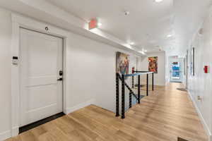 Entrance foyer featuring light wood finished floors, recessed lighting, and baseboards