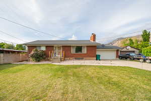 Ranch-style house featuring brick siding, driveway, a chimney, and a garage