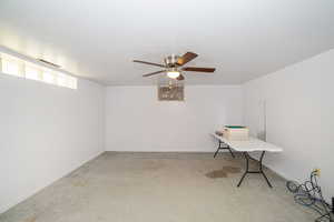 Unfurnished office featuring carpet, a ceiling fan, and baseboards