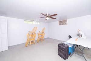 Playroom with carpet floors, ceiling fan, and a desk