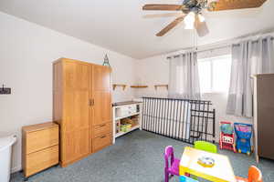 Rec room with ceiling fan and carpet