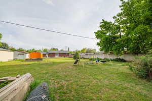 View of yard with an outbuilding and a shed