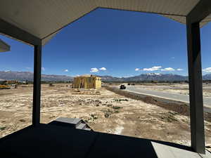 View of yard with a mountain view, a patio, and a view of countryside