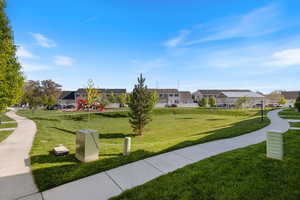 View of home's community with a residential view and a yard