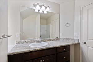 Bathroom with vanity and a shower and toilet