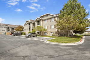 View of property featuring uncovered parking and a residential view
