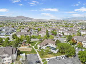 Aerial view of property and surrounding area with nearby suburban area and mountains