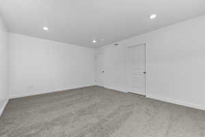 Unfurnished room with carpet floors, recessed lighting, and baseboards