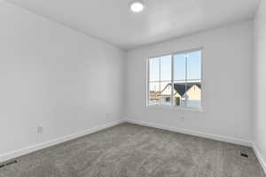 Spare room with carpet flooring and baseboards