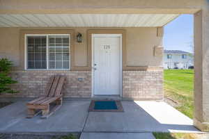 Property entrance with stucco siding and brick siding