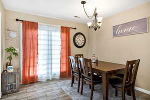 Dining room featuring a chandelier and light wood-style floors