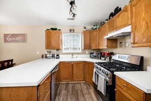 Kitchen featuring appliances with stainless steel finishes and a peninsula
