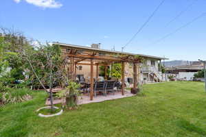 Back of property with a pergola, a patio, and stairs