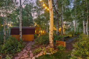 View of yard featuring a storage unit and an outdoor structure