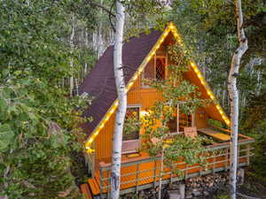 View of front of home featuring roof with shingles and board and batten siding