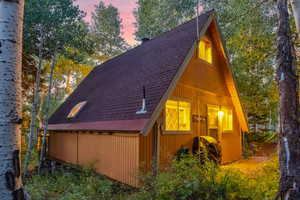 View of home's exterior featuring roof with shingles