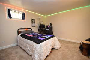 Bedroom featuring carpet flooring and baseboards
