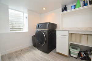 Laundry room featuring washer / clothes dryer, cabinet space, recessed lighting, and baseboards