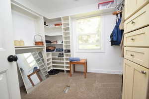 Walk in closet featuring carpet