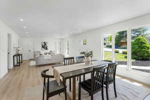 Dining room with light wood-type flooring and recessed lighting