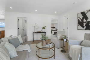 Living area featuring light wood-style flooring and recessed lighting