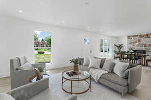 Living room featuring light wood finished floors, recessed lighting, and baseboards