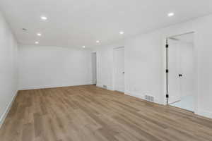 Empty room with recessed lighting, light wood-type flooring, and baseboards