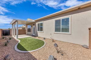 Back of house with a patio, fence, and stucco siding