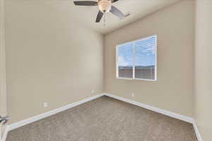 Unfurnished room with carpet floors, ceiling fan, and baseboards